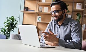 An interpreter at a laptop with a headset